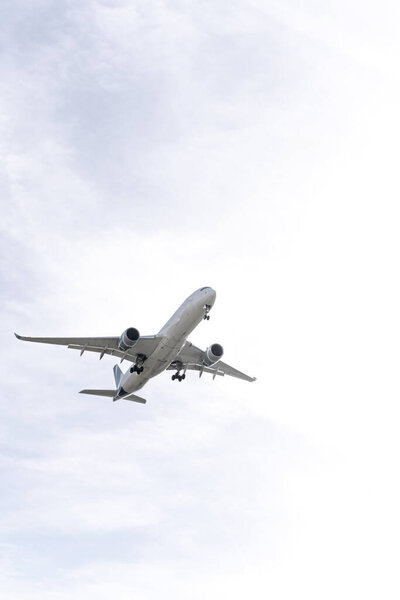 Вид фюзеляжа пассажирского самолета в несколько облачный день, приближающийся к взлетно-посадочной полосе Мадрида, аэропорт Барахас