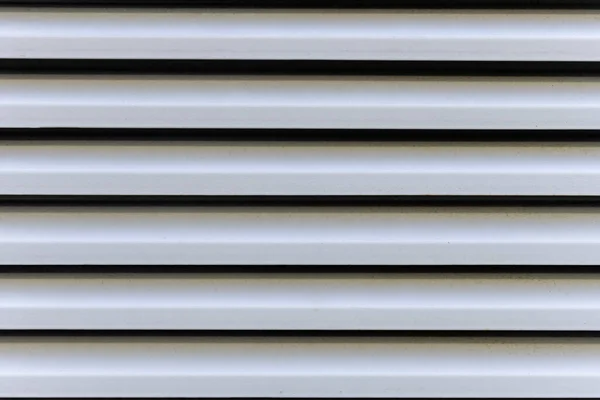 A gray painted metal blind