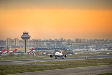 Bir yolcu uçağı pistte yarışıyor ve yükselmek için ivme kazanıyor. 