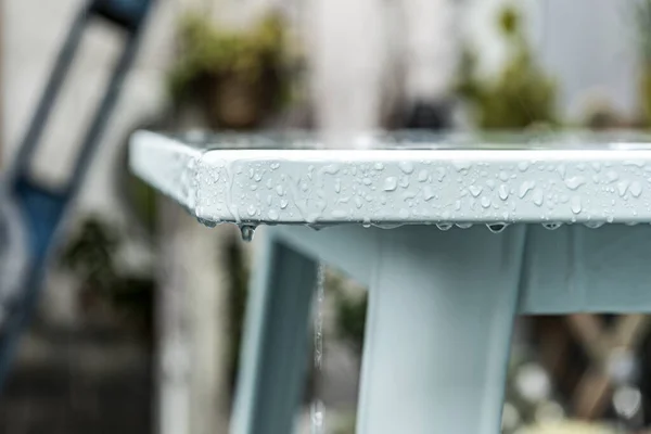 rainy days on a terrace with metal furniture