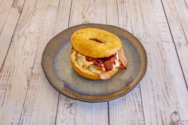  Simit servis etmenin klasik bir yolu krem peynir, füme somon, domates dilimleri, kırmızı soğan ve kapari eşliğinde ikiye bölünüp kızartılır.