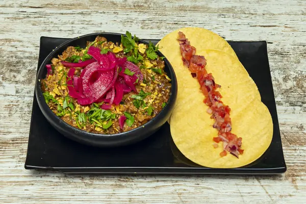 Cochinita Pibil Tacos: Fıstık ve portakal suyunda marine edilmiş, muz yapraklarında yavaş pişirilmiş domuz eti