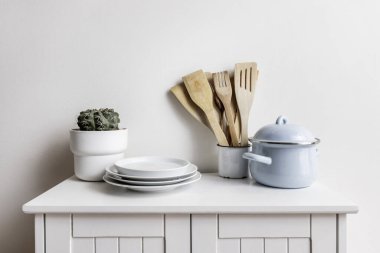 Tencereli küçük beyaz ahşap bir alet. 