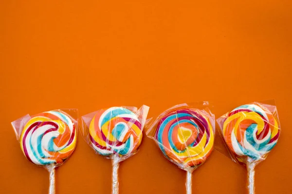 Colorful Spiral Lollipop Candy Stick Orange Background — Stock Photo, Image