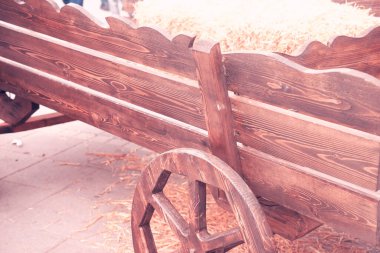 old wooden cart stands in the yard clipart