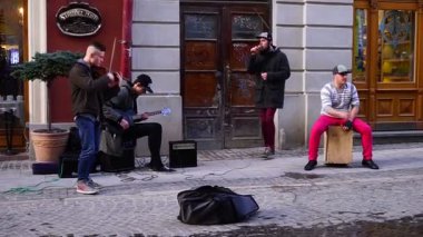 LVIV, UKRAINE. 10 MARCH 2019: Street musicians play music for people in the center of the old city of Lviv