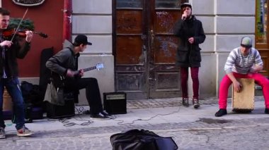 LVIV, UKRAINE. 10 MARCH 2019: Street musicians play music for people in the center of the old city of Lviv
