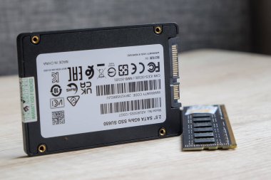 Close up of computer SSD card with ram memory on wooden table