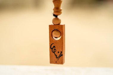 Wooden prayer beads on a blurred background. Macro shot