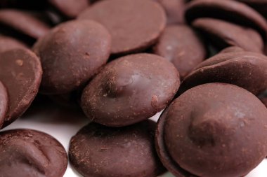 A pile of chocolate dark button. Macro shot
