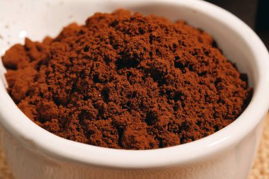 Macro shot of coffee grounds in a bowl
