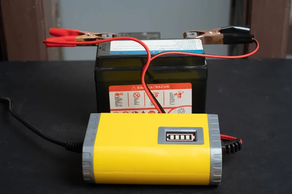 Charging motorcycle battery, battery maintenance and repair concept