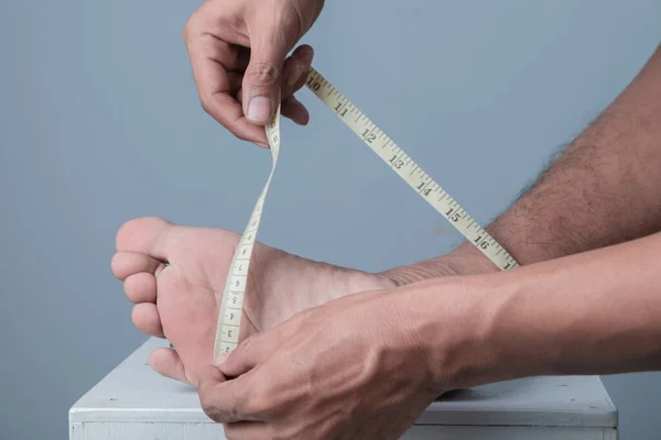 Close Man Measuring His Foot Size Measuring Tape Light Blue — Stock Photo, Image