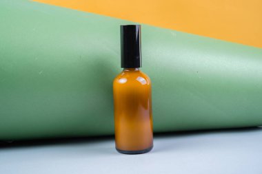 Yeşil karton arka planda cam toner şişesi. Güzellik ürünü paketleme görüntüsü