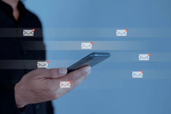 Businessman using smartphone with email icon, email inbox electronic communication graphic concept.