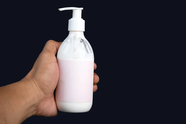 Lotion Bottle Male Hand Isolated Dark Background — Stock Photo, Image