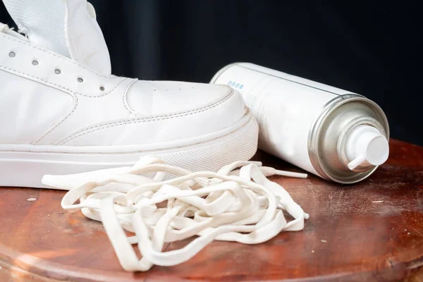 Leather white sneakers with care kit. Leather footwear care concept