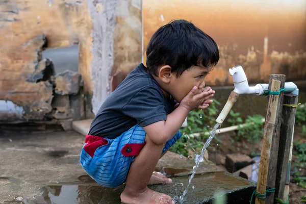 stock image Boys playing in the fountain from the tap water