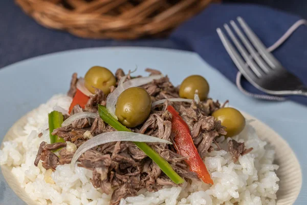 Extreme close up of Shredded meat with rice and olives, typical Cuban food.