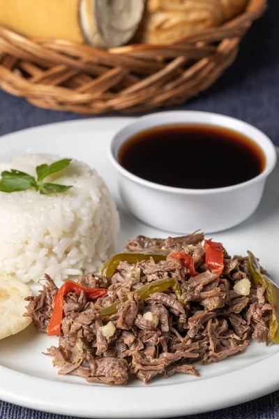 Shredded meat with rice and sauce, typical Cuban food.