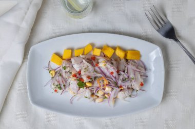 Top view of Ceviche, typical fish-based dish of Peruvian cuisine, presented in a rectangular plate. clipart