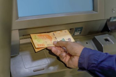ATM 'den Arjantin pezosu çeken bir adamın ayrıntıları..
