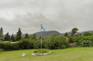 Argentine flag in the Los Menhires archaeological reserve located in the town of El Mollar in Tucuman. clipart