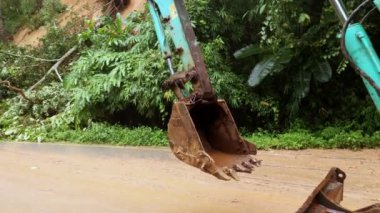 Thailand, Chiangmai, November 02 2022, An excavator goes to cleans up fallen trees after a hurricane. The rescue team is at work. High quality 4k footage