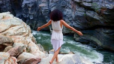 Nehir kıyısında sakin bir an: Doğanın Özünü Çekmek ve Sersemletici Rocky Manzaralarının Ortasında Zarif Pozisyon Vermek. Yüksek kalite 4k görüntü