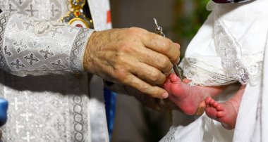 Bir çocuğun vaftiz töreni. Ortodoks Kilisesi 'nde bir çocuğun vaftiz töreni. Rahip, yenidoğan bebeğin ayaklarını kilise yağıyla yağlar. Ortodoksluk kavramı
