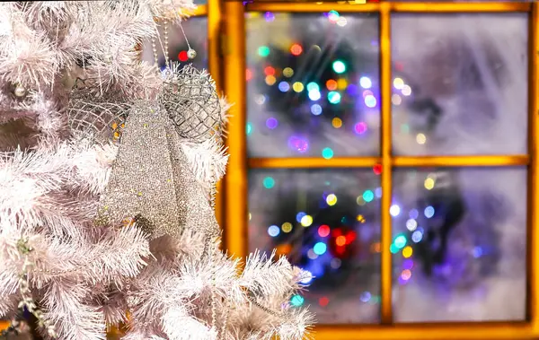 Odanın penceresinin yanındaki dekoratif Noel ağacı ve akşam ışığı, Mutlu Noeller ve yeni yıl, mutlu bayramlar, mutlu an ve kutlama zamanı..