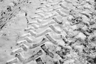 Tire tracks of large wheels from a car or tractor on fresh snow. Imprints, tire tracks on snow. clipart