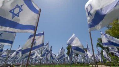 Mavi gökyüzünün altında dalgalanan sayısız İsrail bayrağı ulusal gururun vatansever bir sahnesini simgeliyor.