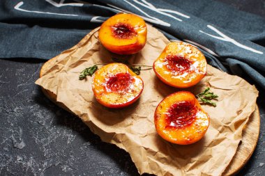 Arkaplanda bal ve tarçınlı fırında şeftali. Yaz tatlısı