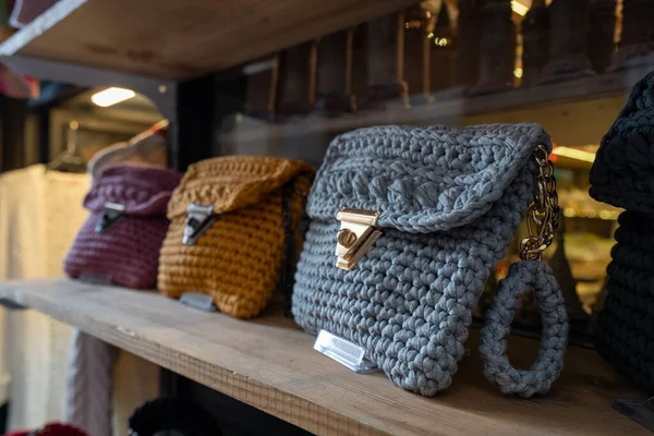 Colorful knitted women bags on the shop.