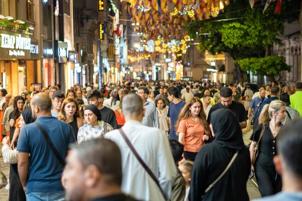 stock image Crowd of people on the main pedestrian Taksim Istiklal Street at night. Istanbul, Turkey - June 20, 2023.