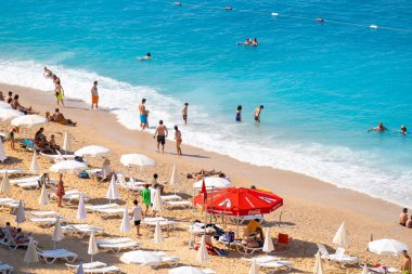Turistler Kaputa 'da güneşleniyor ve yüzüyorlar. Kaputas Plajı, Kas ve Kalkan arasında küçük bir plajdır. Antalya, Türkiye - 10 Temmuz 2023.