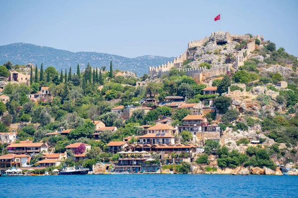 Stock image The view of Kalekoy town from Kekova Bay. Simena Castle is located on Turkey's stunning Mediterranean coast in the Kekova Region between the modern town of Kas. Antalya, Turkey - July 10, 2023.