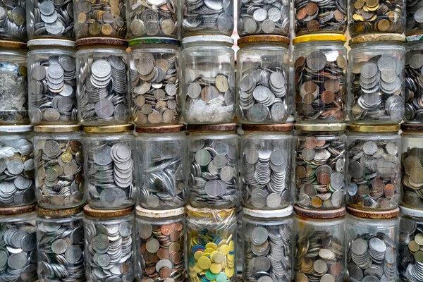 Old coins in jars isolated.