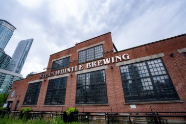 Steam Whistle Brewing is an independent brewery in Toronto. Toronto, Canada - May 25, 2024. clipart