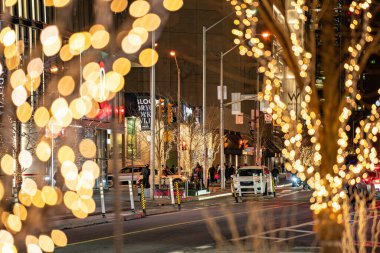 Christmas lights on Bloor Street in Yorkville at evening. Toronto, Canada - December 11, 2024. clipart