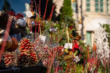 Christmas decorations and flowers in front of the florist shop. clipart