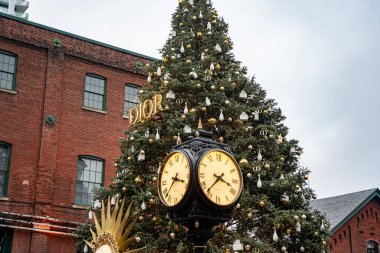 Dior Christmas Tree in the Christmas Village in the Distillery District. View of the Toronto Christmas Market. Toronto, Canada - December 24, 2024. clipart