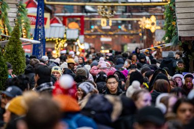 Crowd of people visiting the Christmas Village in the Distillery District. View of the Toronto Christmas Market. Toronto, Canada - December 24, 2024. clipart