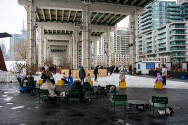 People skating at the Bentway ice rink in Toronto. Toronto, Canada - December 24, 2024. clipart