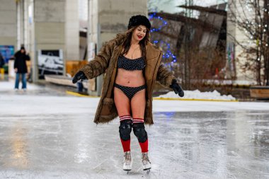 The young women take part in the annual Polar Bear Skate at the Bentway Skate Trail in Toronto. Toronto, Canada - December 29, 2024. clipart