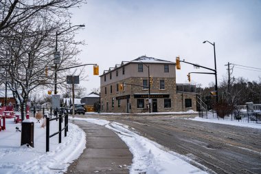 Winter view of Mill Street in Elora, Ontario. Elora, Canada - January 2, 2025. clipart