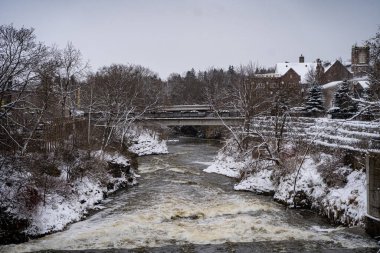 Winter view of the Grand River in the town of Fergus, Ontario. clipart