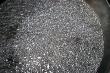 Bir tencerede kaynayan suya yakın çekim