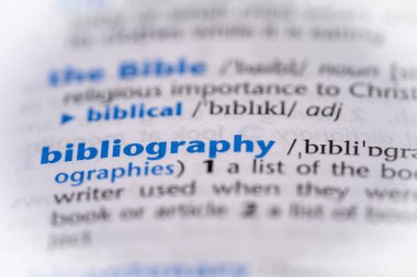 Bibliography word in a dictionary. Selective focus, close up. clipart